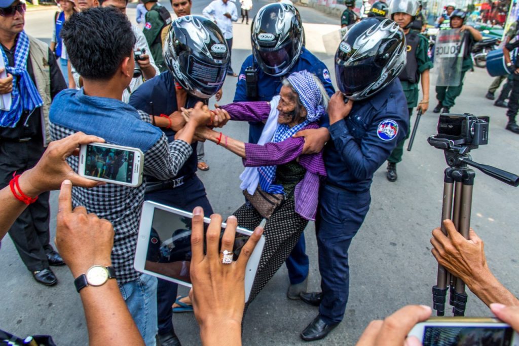 woman being pulled away by police