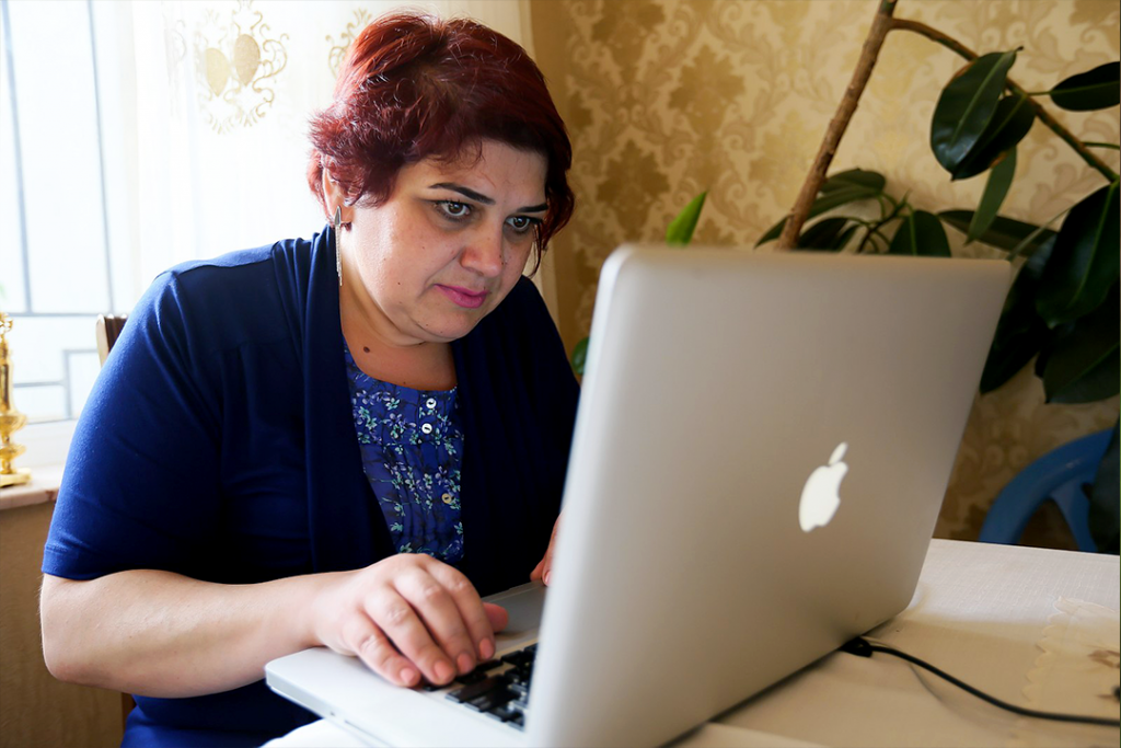 Journalist Khadija Ismayilova sits at a laptop computer as she inspects the page of Panama Papers.