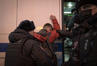 Young peace protester detained by Russian police.