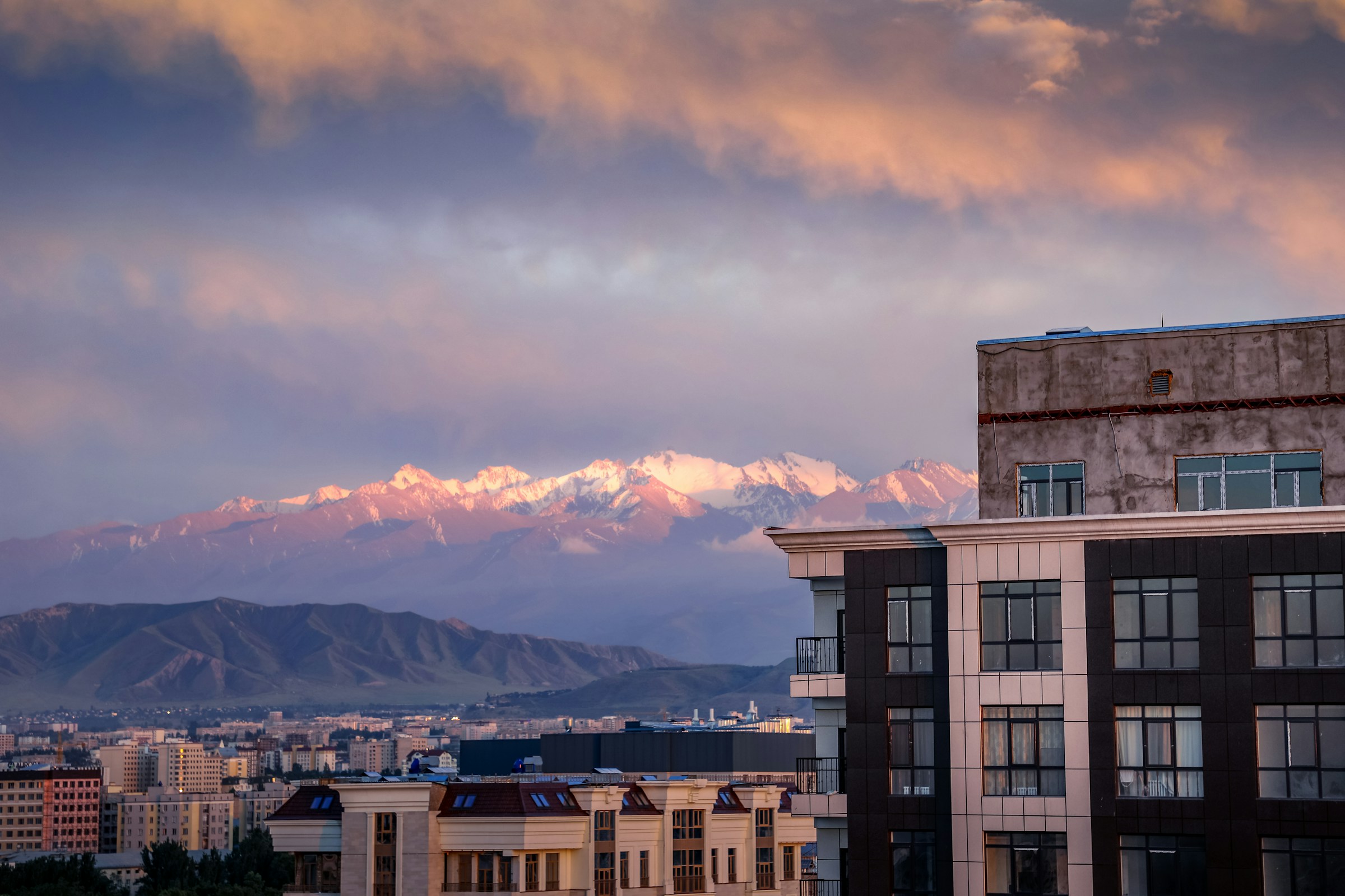 The skyline of Bishkek against purplish mountains