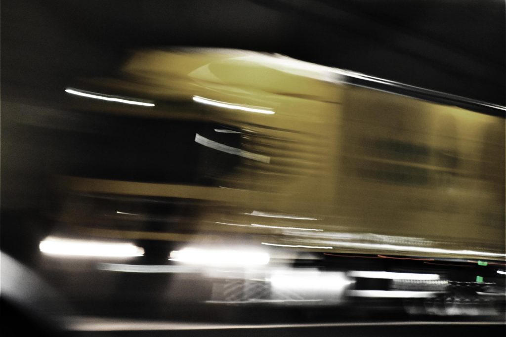 A yellow truck in motion-blur.