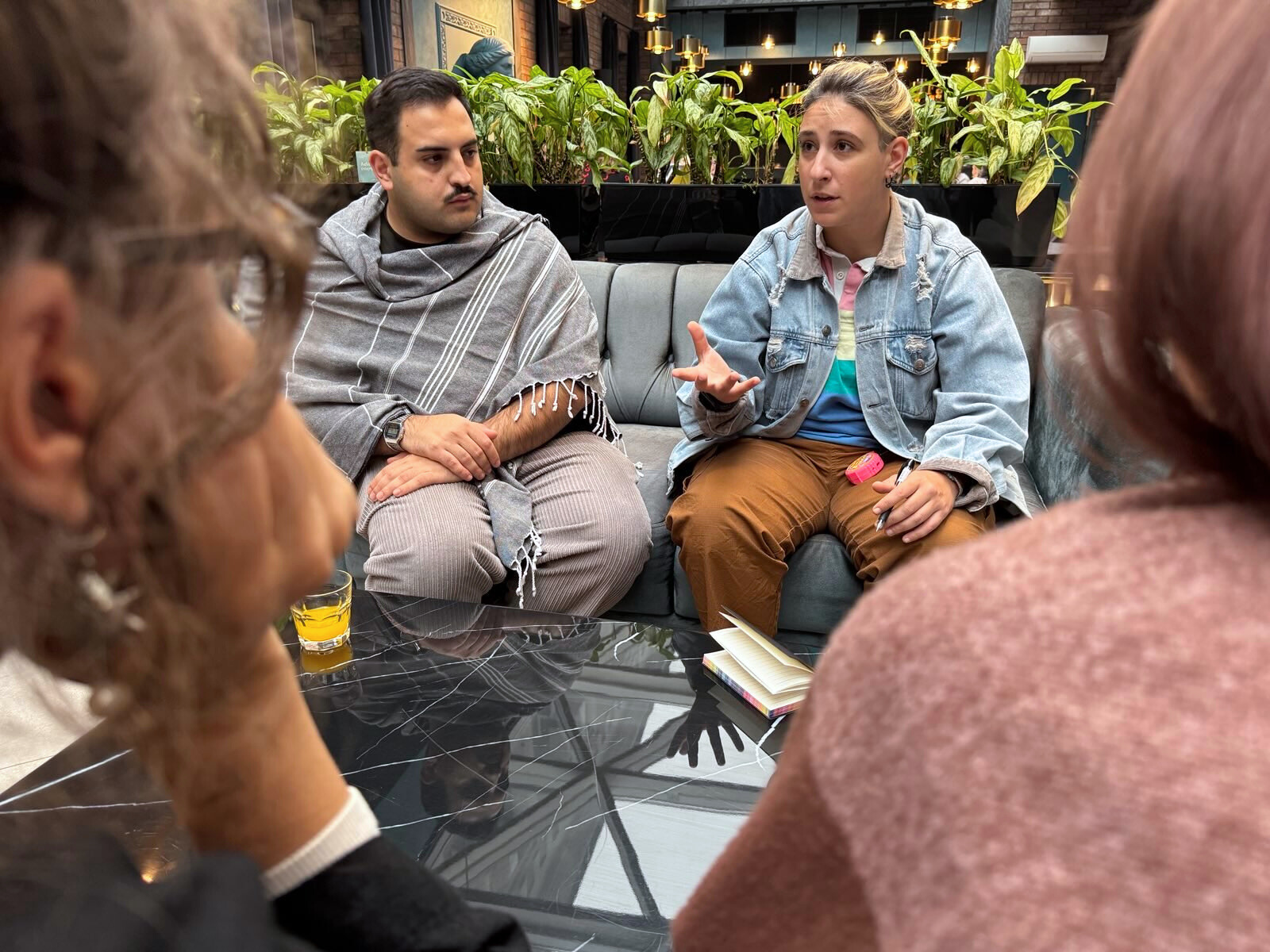 Two workshop participants talking with each other while seated