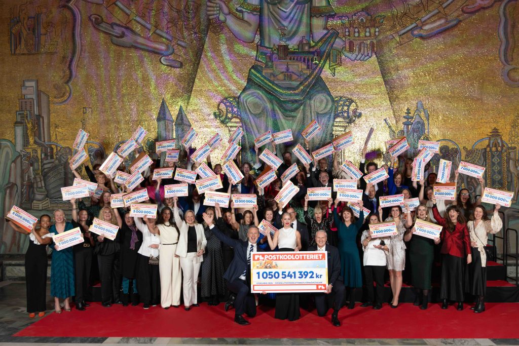 En gruppbild från utdelningen av Postkodlotteriets stöd 2026, med representanter från de organisationer som tog emot stöd.